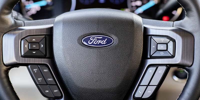 The steering wheel of a Ford model vehicle with the "Ford" logo centered in the picture. - Jack Madden Ford Norwood, MA