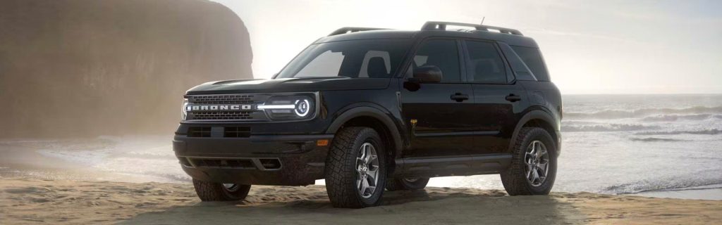 An all-new Black 2024 Ford Bronco Sport parked on the beach at the end of the tide. - Jack Madden Ford Norwood, MA